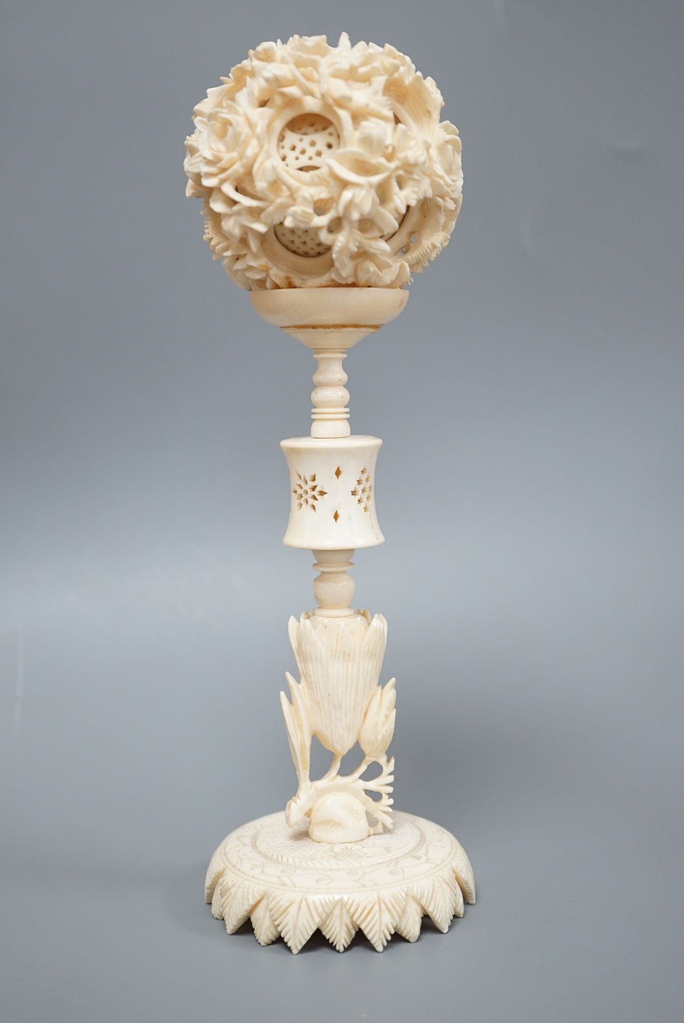 An early 20th century Chinese ivory concentric puzzle ball and stand 20cm total height